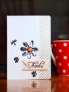 Red dotted cup of coffee with thank you card