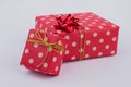 Red dotted gift boxes on gray background.