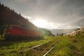 Red DR Class 130 DB Schenker locomotive and romanian CFR commuter train Royalty Free Stock Photo