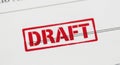 Red draft stamp on paper document revealing preliminary document status for review Royalty Free Stock Photo