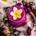 Red Dragon fruit juice in a glass, decorated with Plumeria flower over flowery fabric. Top view. Square image. Royalty Free Stock Photo