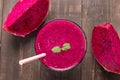 Red dragon fruit smoothie on wooden background. Royalty Free Stock Photo