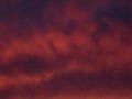 Red dramatic evening cumulus clouds in the sky. Colorful cloudy sky at sunset. Sky texture, abstract nature background Royalty Free Stock Photo