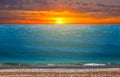 Dramatic sunset over the sandy sea beach Royalty Free Stock Photo