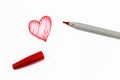 The red drawing of heart sign with pen on white background Royalty Free Stock Photo