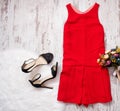 Red dress, black shoes and bouquet. Imitation fur on a wooden background, fashionable concept Royalty Free Stock Photo