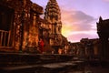 A red dress girl staring at the ancient Angkor Wat