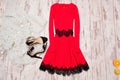 Red dress with lace, black shoes and a Imitation fur on a wooden background, fashionable concept, top view Royalty Free Stock Photo