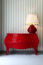 Red dresser and table lamp