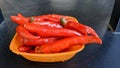 Red dried chili in a bowl with white background. A bowl of moist red chilli peppers Royalty Free Stock Photo