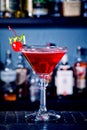 Red drink cocktail with cherry in martini glass, cherry and lime peel Royalty Free Stock Photo