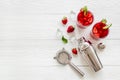 Red drink coktail with strawberry, ice and mint. Cocktail making bar tools