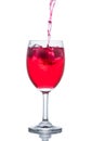 Red drink with ice cubes in a glass, Red soda in glass wine. Royalty Free Stock Photo