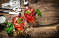 Red drink with ice, mint leaves and strawberry. Cocktail Royalty Free Stock Photo