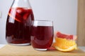 red drink juice grape red wine in a glass of sangria in a glass next to lie fruit oranges grapefruit close-up. drinks for the Royalty Free Stock Photo