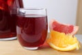 red drink juice grape red wine in a glass of sangria in a glass next to lie fruit oranges grapefruit close-up. drinks for the Royalty Free Stock Photo