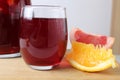 red drink juice grape red wine in a glass of sangria in a glass next to lie fruit oranges grapefruit close-up. drinks for the Royalty Free Stock Photo