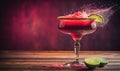 a red drink with a lime wedge and a splash of water Royalty Free Stock Photo