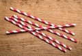 Red drinking straws on wood background