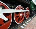 Red driving wheels of a steam locomotive, connected by levers Royalty Free Stock Photo