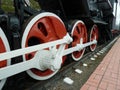 Red driving wheels of a steam locomotive, connected by levers Royalty Free Stock Photo