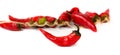 Red dry chili pepper in front of bunch of other peppers on white background, suitable for header or banner Royalty Free Stock Photo