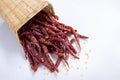red dry chili peppers in basket on white background. Royalty Free Stock Photo