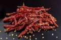 Red dry chili peppers on black background. Royalty Free Stock Photo