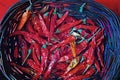 Red dry chili peppers in straw basket Royalty Free Stock Photo