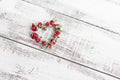 Red dry roses scattered on the light wooden background. Love Royalty Free Stock Photo