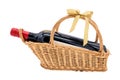 Red dry wine bottle on weave basket isolated on white Royalty Free Stock Photo