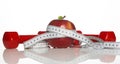 Red Dumbbells, fresh red apple and white measuring tape Royalty Free Stock Photo