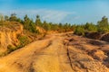 Red dust and mud road in poor condition with large holes Royalty Free Stock Photo