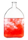 Red dye dissolves in water in bottle isolated Royalty Free Stock Photo