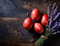 Red painted Easter eggs with lavender on dark rustic background Royalty Free Stock Photo