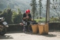 Red dzao ethnic minority woman sewing in Sa Pa, Lao Cai province, Vietnam. elderly woman makes souvenirs on the street