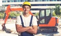 Red earthmover with strong latin american construction worker Royalty Free Stock Photo