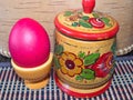Red Easter egg and a salt in wood a salt shaker. Colorful Easter eggs - part of the passover meal. Easter Royalty Free Stock Photo
