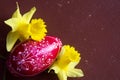 Red Easter Egg And Two Yellow Daffodills