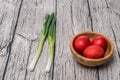 Red Easter Eggs in a Bowl with spring onion. Royalty Free Stock Photo