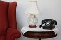Retro dial phone, decorative lamp on round chair side table