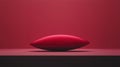 A red, egg-shaped object with a black line on its side sits on a black surface against a red background. Royalty Free Stock Photo