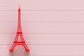 Red eiffel tower on red wooden board.