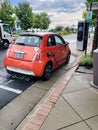 Red Electric Car in the parking lot of Charging Station. The process of connecting a car to a charging station Royalty Free Stock Photo