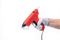 Red electric glue gun. On a white isolated background.