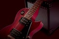 Red electric guitar and classic amplifier on a dark background Royalty Free Stock Photo