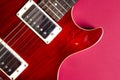 Red electric guitar close-up. Guitar in the style of Les Paul macro. Royalty Free Stock Photo
