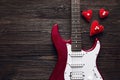 Red electric guitar with hearts on a dark wooden background. Spa Royalty Free Stock Photo