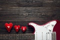 Red electric guitar with hearts on a dark wooden background. Spa Royalty Free Stock Photo