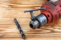 Red Electric hand drill set on wooden table Royalty Free Stock Photo